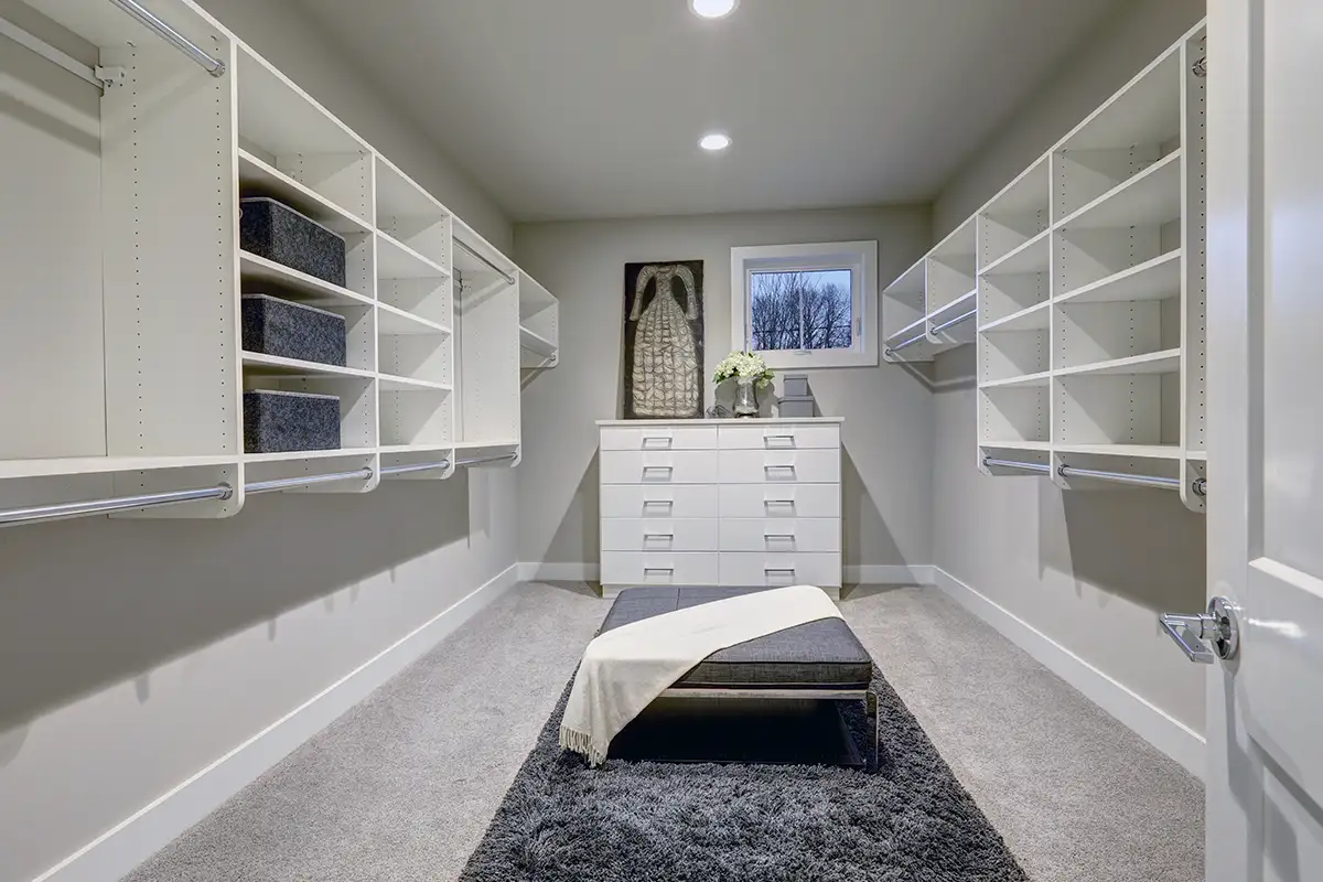 large walk in closet with custom shelving and extra storage space, remodeling project by Expressions Remodeling in St. Louis, MO