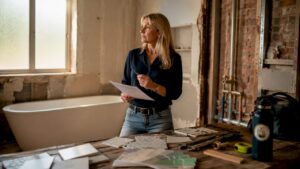 Woman reviewing bathroom remodel checklist in renovation