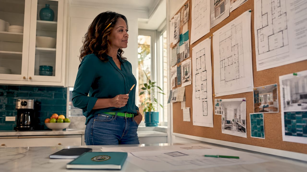 Woman reviewing home remodeling plans at table