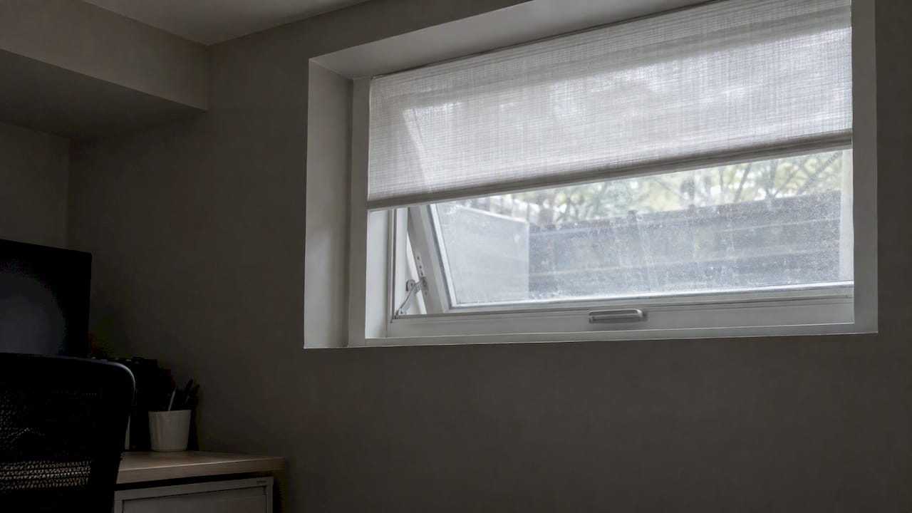 Sheer shade over a small basement window
