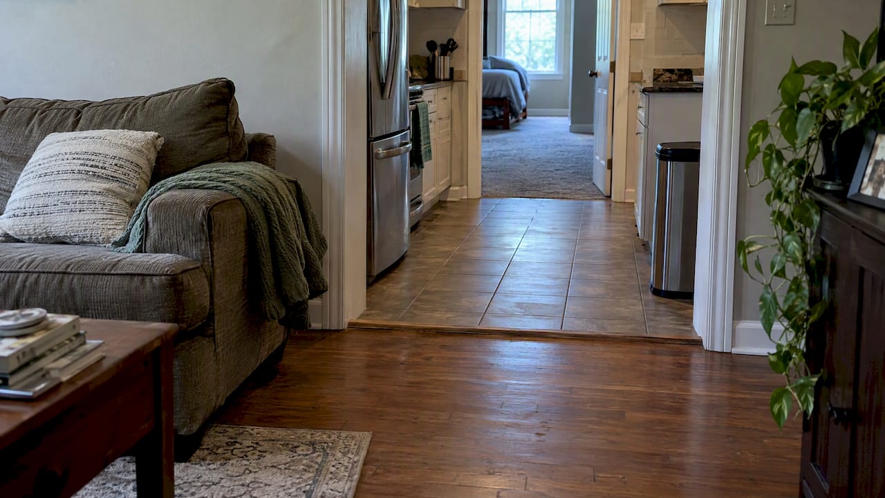 Three flooring materials meet across home rooms