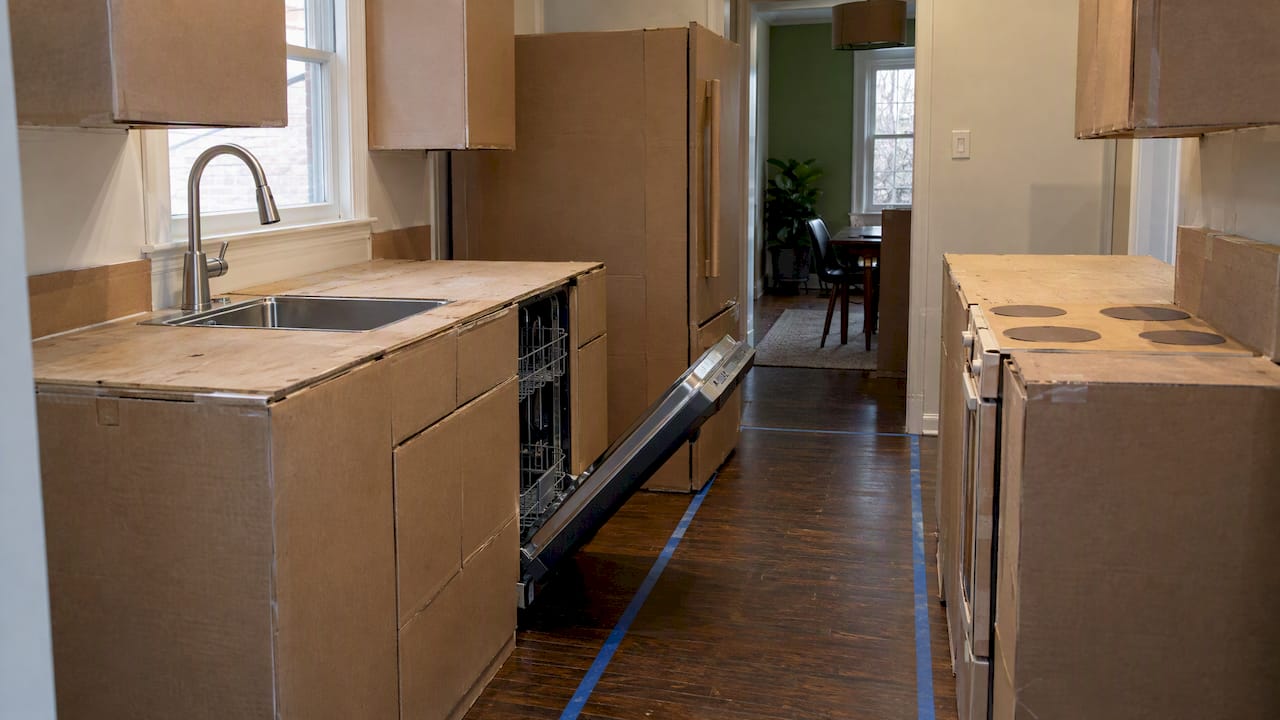 Cardboard cabinet mockup showing a blocked kitchen aisle